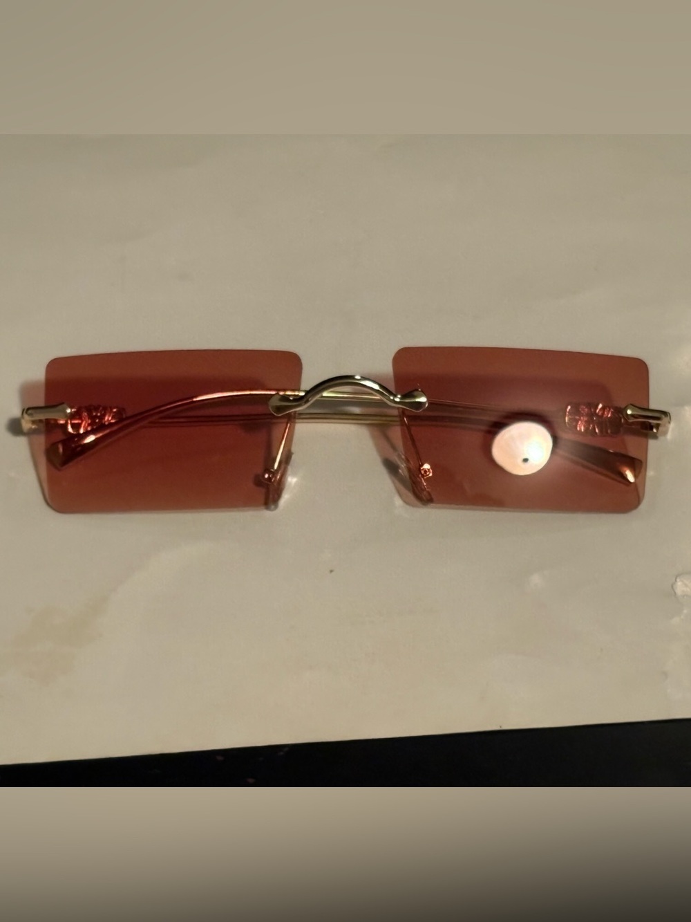 Rimless Salmon-Tinted Sunglasses with Gold Bridge